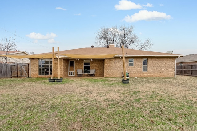 rear view of house with a yard