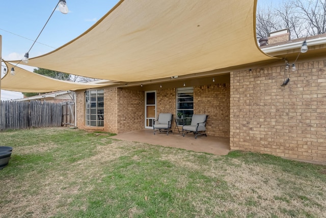 back of property featuring a patio area and a yard