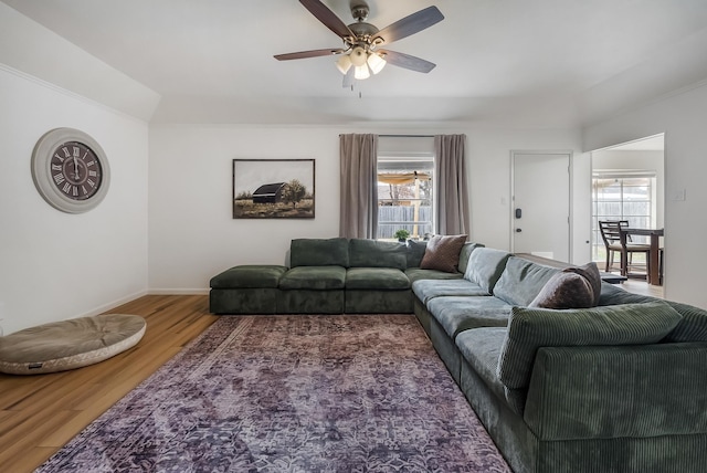 living room featuring wood-type flooring, a healthy amount of sunlight, and ceiling fan