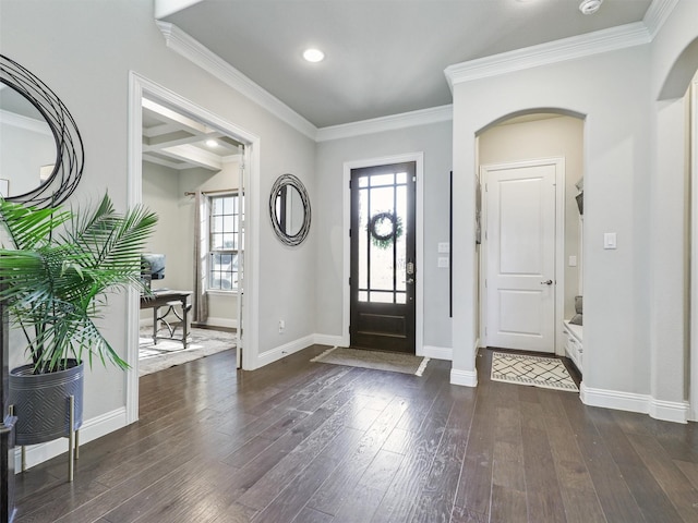 entrance foyer with beamed ceiling, ornamental molding, and dark wood-type flooring