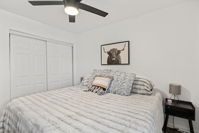 bedroom with a closet, baseboards, and ceiling fan