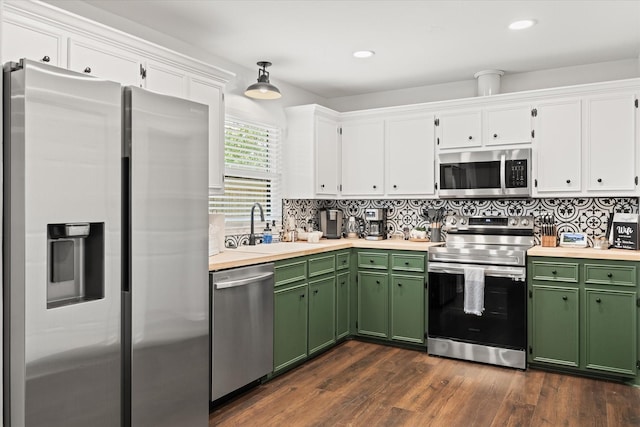 kitchen featuring green cabinetry, decorative backsplash, stainless steel appliances, white cabinetry, and a sink