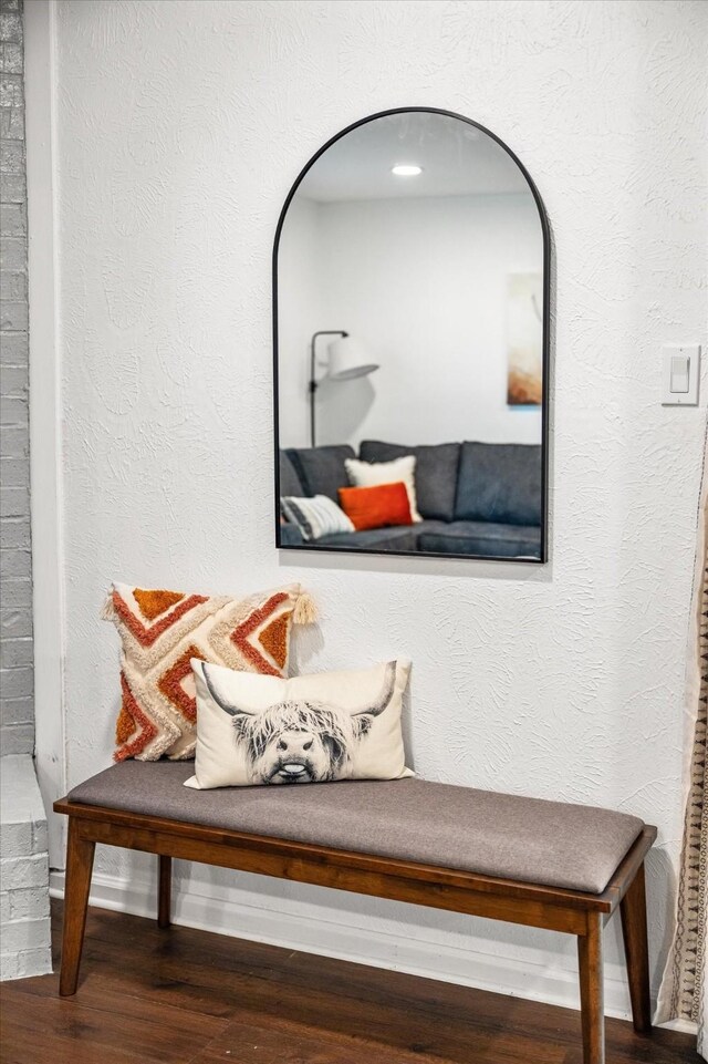 interior details featuring wood finished floors and a textured wall