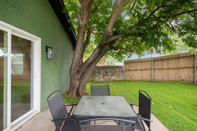 view of patio featuring outdoor dining area and fence