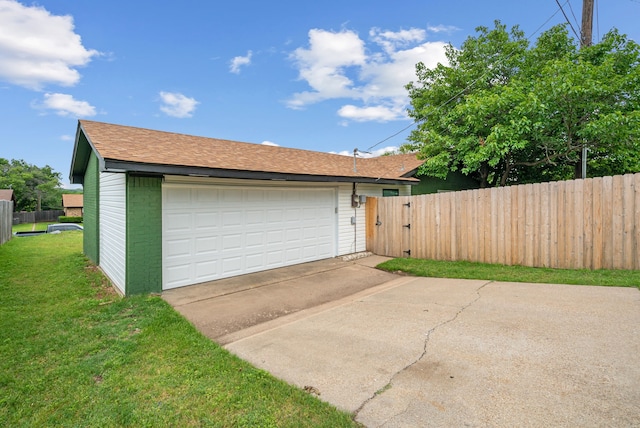 detached garage featuring fence