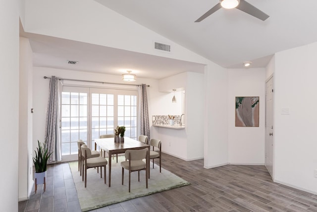 dining space featuring ceiling fan, hardwood / wood-style floors, and lofted ceiling