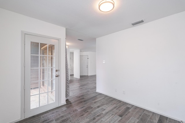 unfurnished room with dark hardwood / wood-style flooring