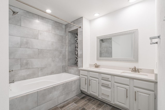 bathroom featuring vanity and tiled shower / bath combo