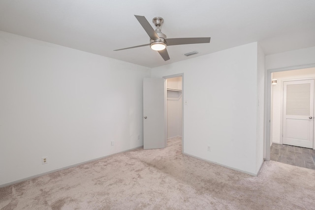 spare room with light colored carpet and ceiling fan