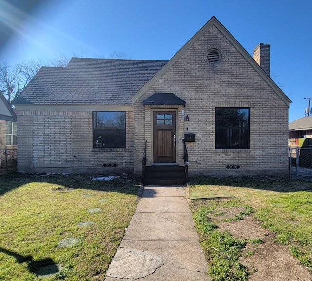 view of front of home with brick siding and a front lawn