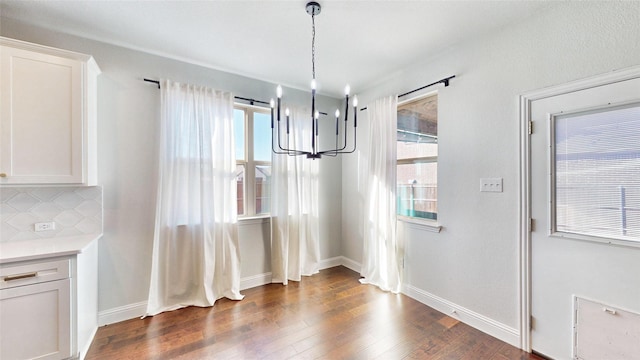 unfurnished dining area featuring dark wood-type flooring