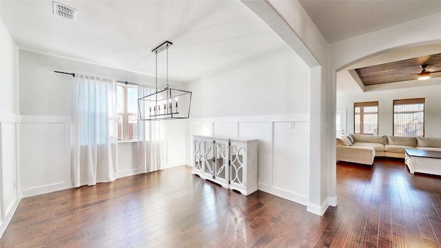 dining room featuring ceiling fan with notable chandelier, dark hardwood / wood-style floors, and plenty of natural light