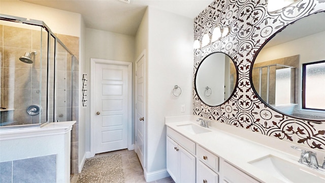 bathroom featuring a shower with door, tile patterned floors, and vanity