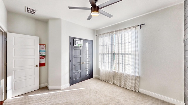 unfurnished bedroom with carpet floors and ceiling fan