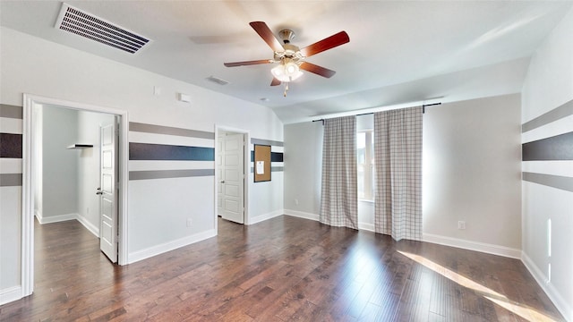 spare room featuring ceiling fan, dark hardwood / wood-style floors, and vaulted ceiling