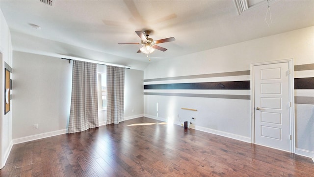 empty room featuring lofted ceiling, ceiling fan, and dark hardwood / wood-style flooring