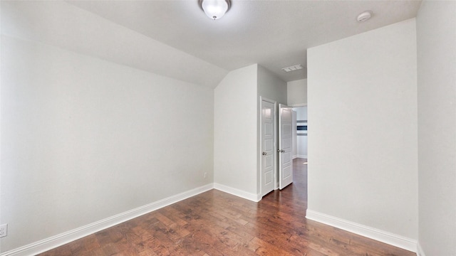 interior space featuring vaulted ceiling and dark hardwood / wood-style floors