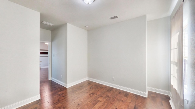 spare room featuring dark hardwood / wood-style floors