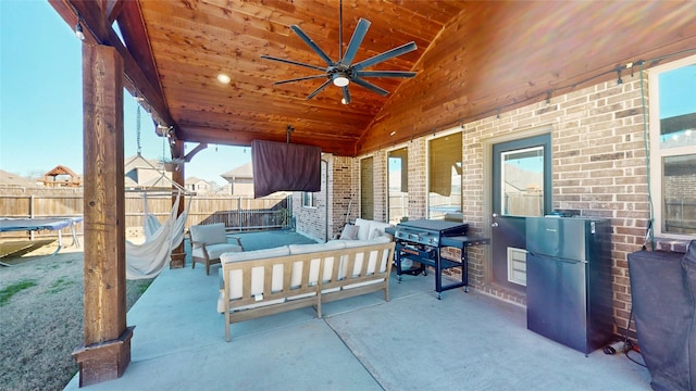 view of patio / terrace featuring area for grilling, an outdoor living space, and ceiling fan