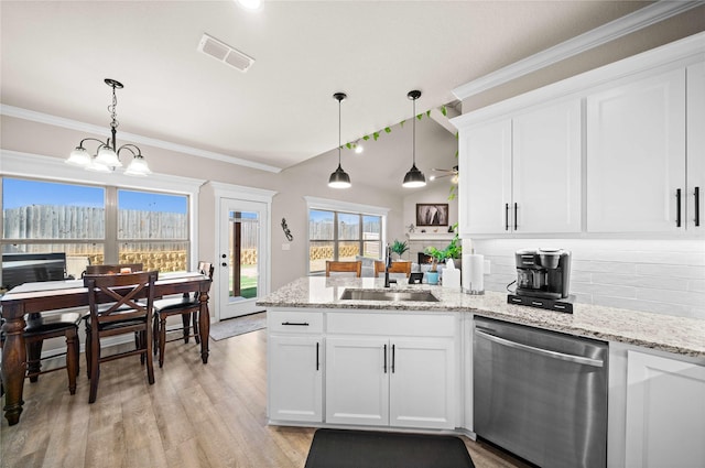 kitchen with sink, dishwasher, white cabinetry, and pendant lighting