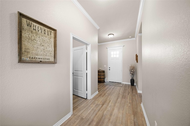 hall featuring light hardwood / wood-style flooring and crown molding