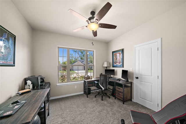 carpeted home office featuring ceiling fan