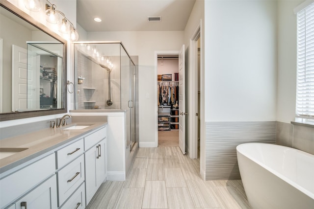 bathroom featuring vanity and plus walk in shower