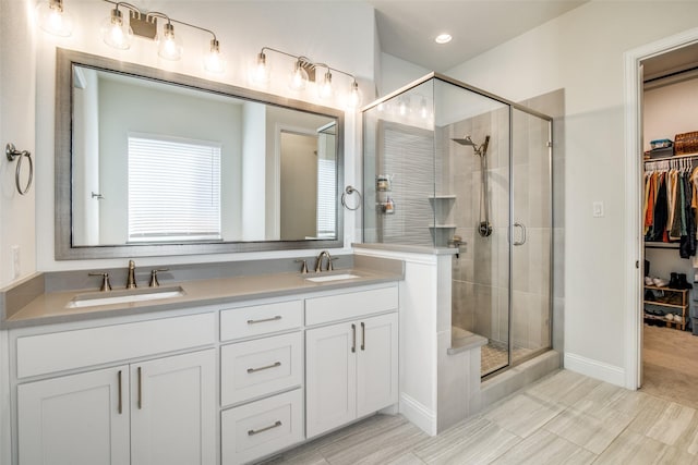 bathroom with a shower with door and vanity