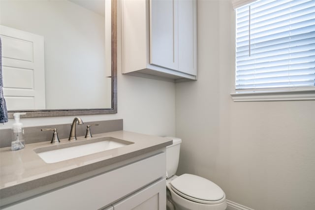 bathroom with toilet and vanity