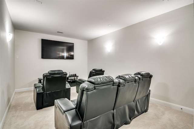 home theater room with light colored carpet