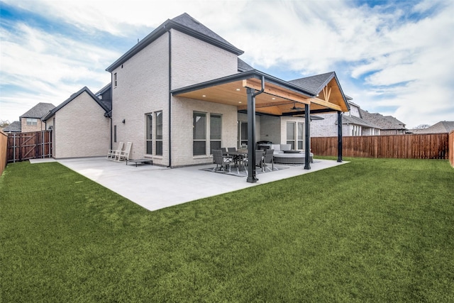 back of house with a patio area, a lawn, and ceiling fan