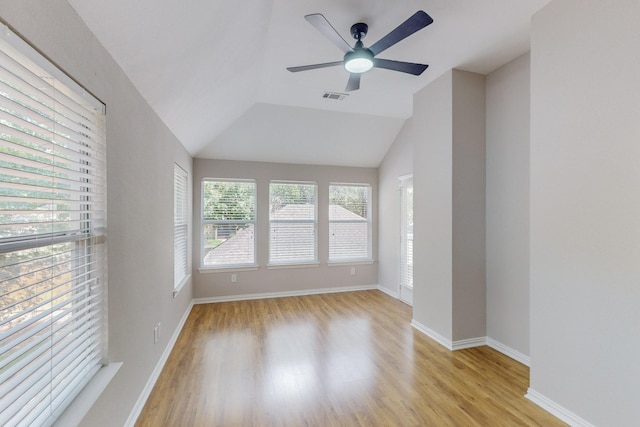 spare room with ceiling fan, lofted ceiling, and light wood-type flooring