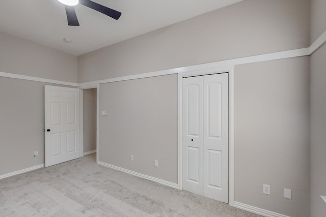 unfurnished bedroom with a closet, ceiling fan, and light carpet