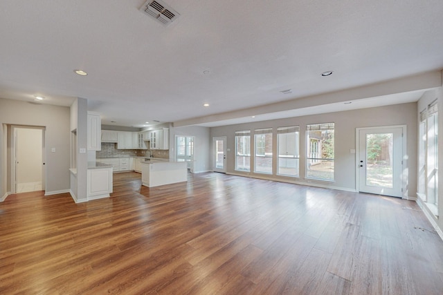 unfurnished living room with hardwood / wood-style floors