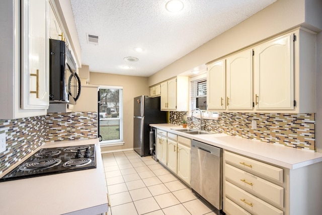 kitchen featuring wine cooler, sink, black appliances, light tile patterned floors, and backsplash