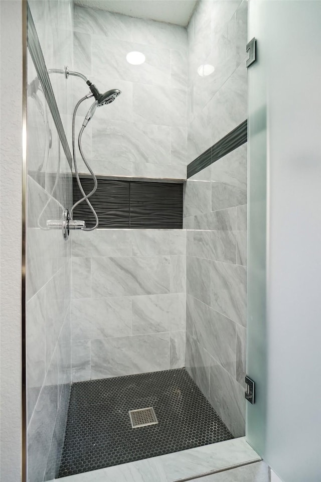 bathroom with tiled shower