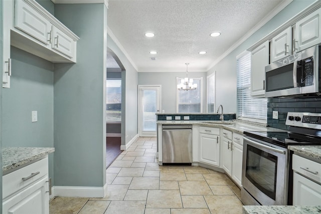 kitchen with sink, a textured ceiling, white cabinets, and stainless steel appliances