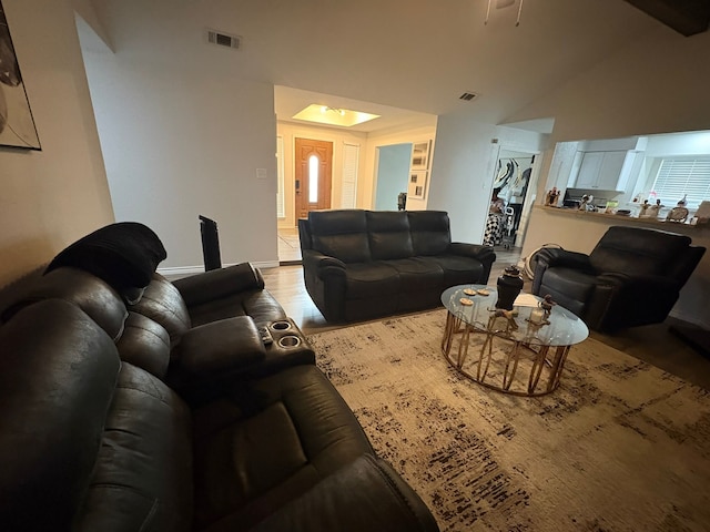 living room featuring light hardwood / wood-style floors and lofted ceiling