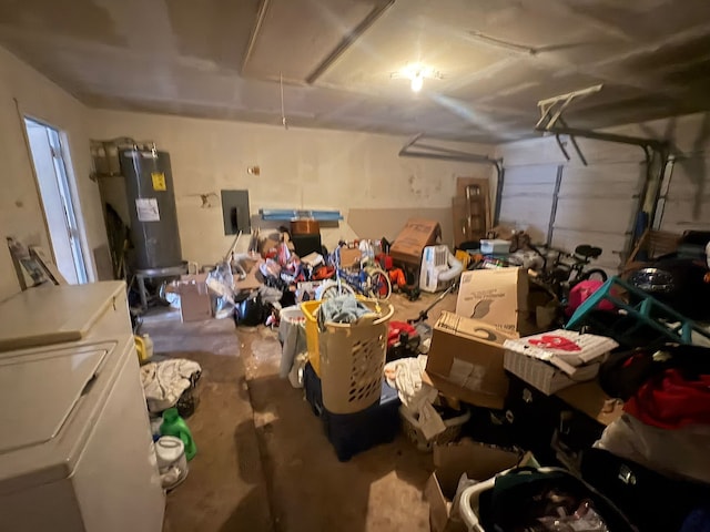 garage with washer and dryer, electric panel, and water heater