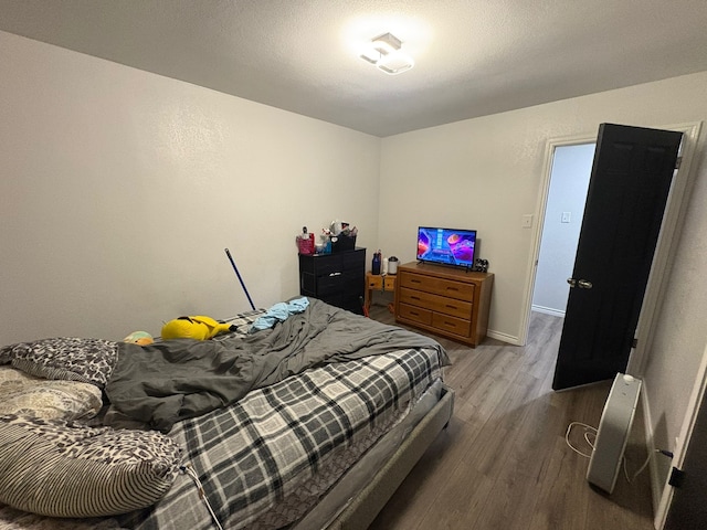 bedroom with hardwood / wood-style flooring