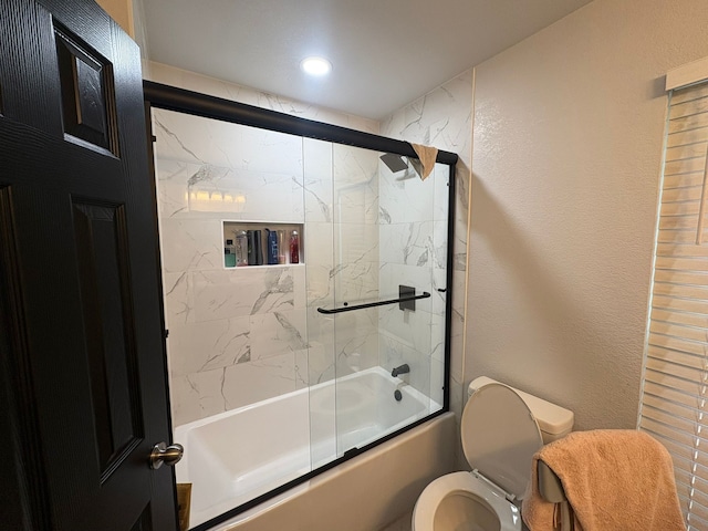 bathroom featuring toilet and enclosed tub / shower combo