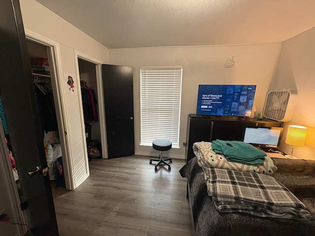 bedroom with a closet and dark hardwood / wood-style floors