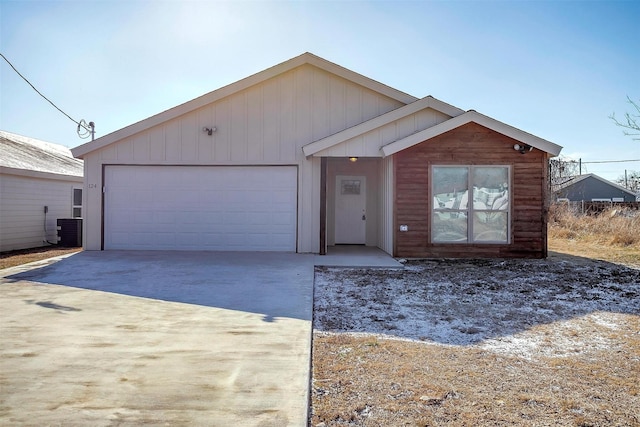 view of front of home featuring cooling unit and a garage