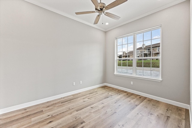 empty room with crown molding, ceiling fan, and light hardwood / wood-style floors