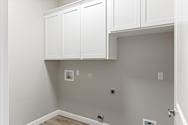 laundry area with gas dryer hookup, wood-type flooring, cabinets, hookup for a washing machine, and hookup for an electric dryer