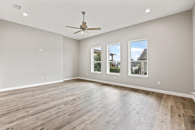 unfurnished room with ceiling fan and light wood-type flooring