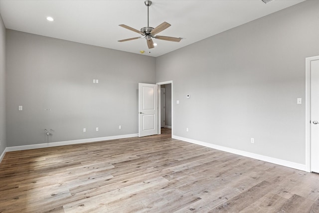 empty room with light hardwood / wood-style flooring and ceiling fan