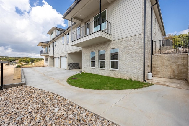 back of house featuring a garage