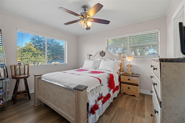 bedroom featuring crown molding, ceiling fan, and wood-type flooring