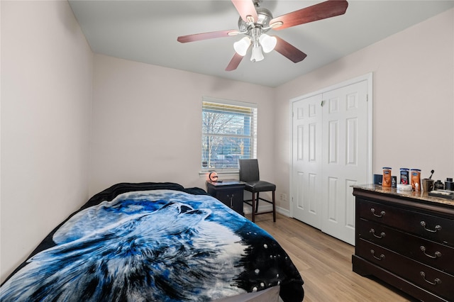 bedroom with ceiling fan, a closet, and light wood-type flooring